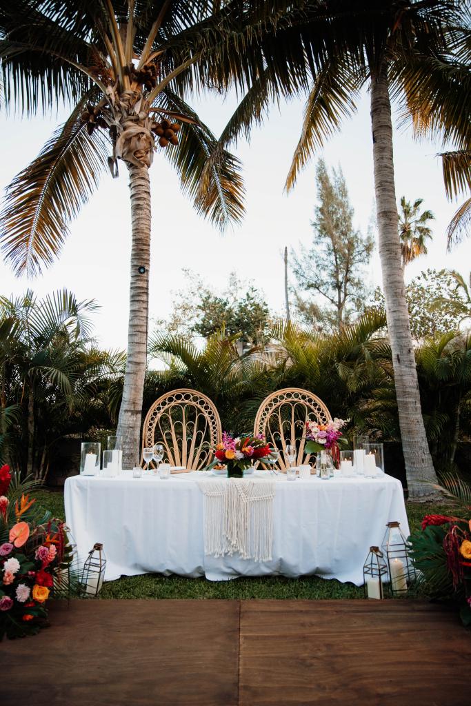 tropical bohemian destination wedding sweetheart table peacock chairs